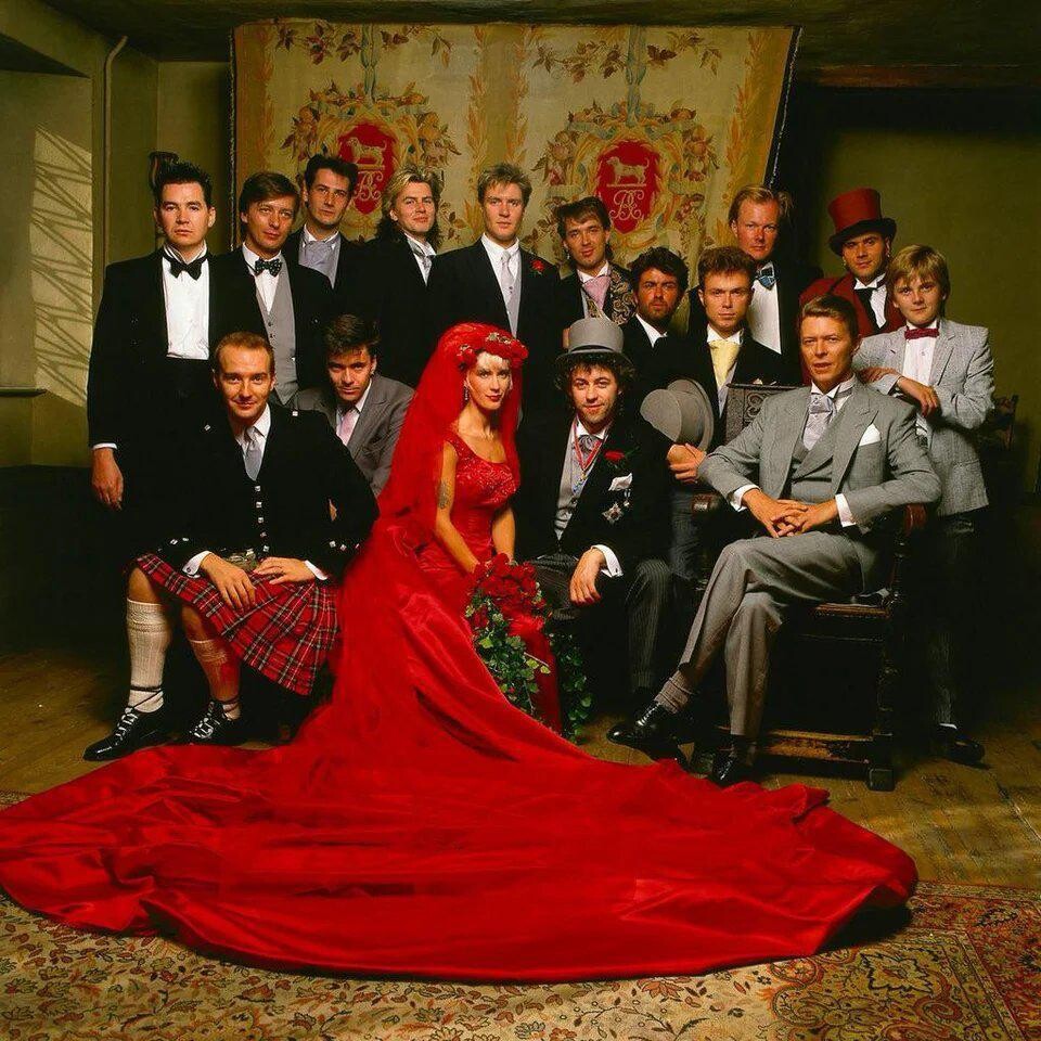 https://radika1.link/2025/07/25/Bob-Geldof-and-Paula-Yates-surrounded-by-David-Bowie-George-Michael-Duran-Duran-Spandau-Ballet-and-Ultravox-in-their-wedding-portrait-198671b124e8e5c618f3.jpg